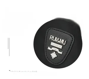 Detail of metal logo and decorative hardware on black water-resistant oxford backpack