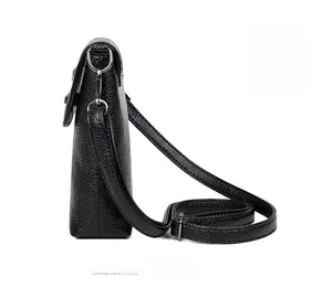 Side view of black lychee grain leather crossbody bag with silver hardware details