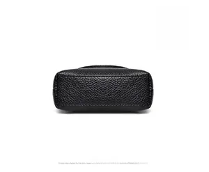Detail view of the black pebble grain leather bottom with neat stitching on the handbag