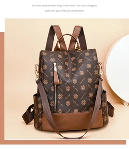 Detail of vintage brown printed backpack showing high-quality leather texture and zipper
