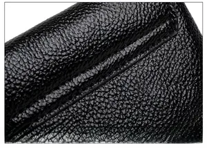 Close-up of litchi texture black leather showing precise stitching on the crossbody bag