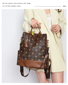 Detail of vintage brown patterned leather backpack with anti-theft zipper and side pockets