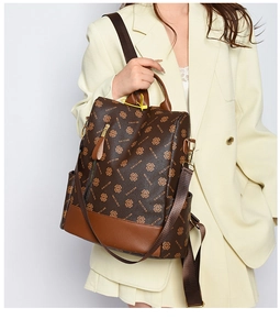 Detail of vintage patterned backpack featuring leather texture and adjustable shoulder straps