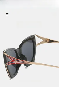 Detail of gold metal temples with red and blue stripes on black cat-eye sunglasses