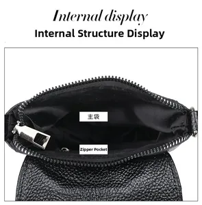 Detail of internal black lychee leather bag compartments with a metal zipper pocket