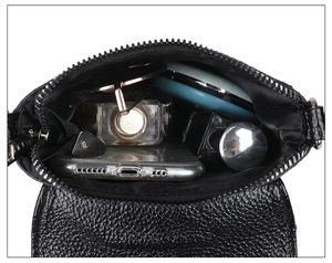 Interior view of black litchi leather bag showing storage for phone, sunglasses and cosmetics
