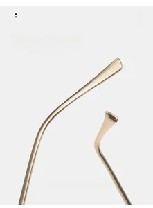 Detail of golden metal curved temples showing ergonomic design and mirror finish