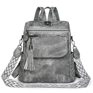 Vintage dark grey multi-purpose backpack with patterned strap and fringe charm
