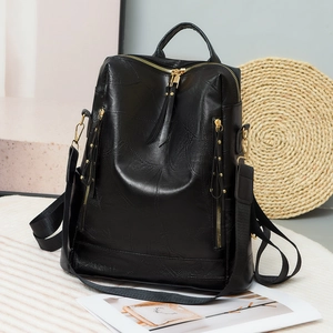 Chic black PU leather women backpack with curved stitching and gold hardware details