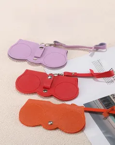 Three premium leather glasses pouches in purple, red, and orange with metallic snap buttons