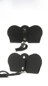 Detail view of premium black faux leather eyewear case with dual metal button fasteners
