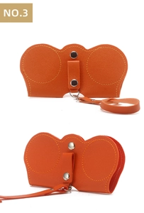 Orange leather sunglasses pouch with double metal buttons and a matching wrist strap