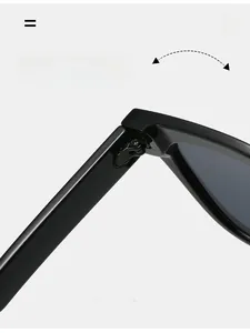 Dettaglio della cerniera resistente su occhiali da sole neri cat eye con struttura solida