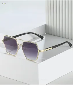 Detail of gold geometric metal sunglasses frame with intricate engraved textures