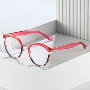 Chic cat-eye metal frame glasses in red with tortoiseshell pattern on geometric blocks