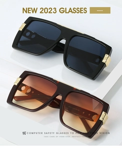 Detail of square oversized sunglasses showing golden metal accents and printed arm specs