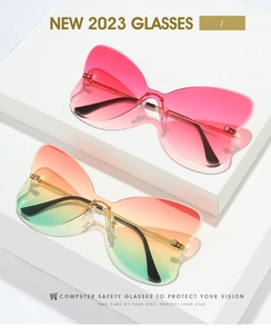 Detail of rimless butterfly sunglasses with gradient lenses on white geometric stands