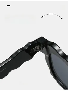 Detail of durable metal hinges and wavy frame on stylish black women's sunglasses