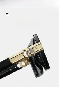 Close-up of black square sunglasses frame with signature gold interlocking hinge detail
