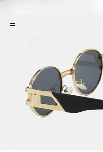 Détail de lunettes de soleil rondes en métal rétro avec monture dorée et verres foncés