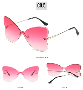 Detail view of pink gradient rimless butterfly sunglasses with gold temples and black tips
