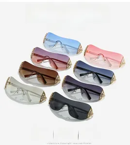 Detailed view of rhinestone encrusted gold metal hinges on stylish rimless sunglasses