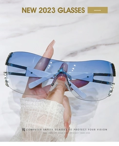 Detail of rimless fashion sunglasses with blue-purple gradient lens and hollow temples