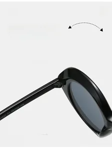 Detail view of durable metal hinges and model numbering on black round sunglasses