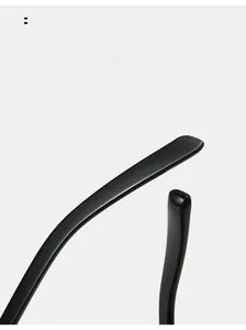 Close-up of curved mirror legs on minimalist round sunglasses with glossy black finish