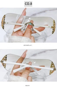 Detail of Y2K rimless sunglasses with sparkling diamond accents and white temples