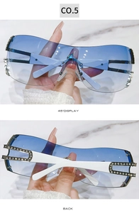Detail view of Y2K rimless sunglasses featuring blue gradient lenses and rhinestone temples