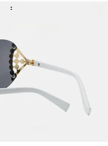 Detail of Y2K sunglasses with white curved legs and golden flower metal hinges