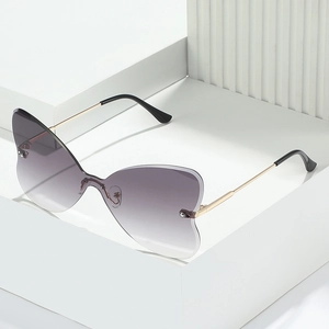Frameless butterfly wing sunglasses with grey gradient lenses and slim gold metal temples