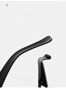 Detailed macro view of ergonomic curved mirror legs on sleek black fashion sunglasses