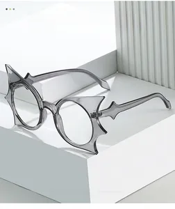 Detail of star-shaped bat wing eyewear frames in translucent smoky gray acetate material