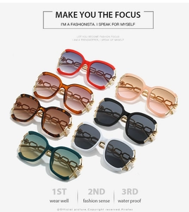 Gros plan de lunettes de soleil oversize colorées avec branches à chaîne dorée