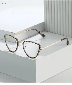 Detail of tortoise shell cat-eye glasses frame with golden metal temples on white stand