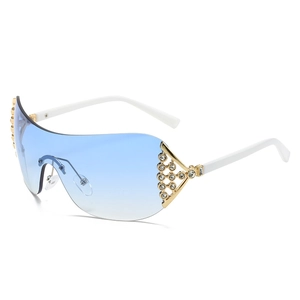 Y2K rimless sunglasses with blue gradient lenses and rhinestone-studded metal accents