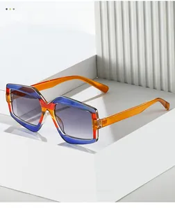Detail of geometric sunglasses with tricolor blue, red, and orange transparent frames