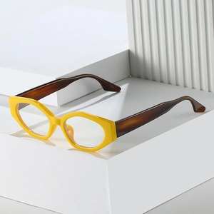 Retro cat-eye glasses frame in bright yellow and tortoiseshell on a white geometric base