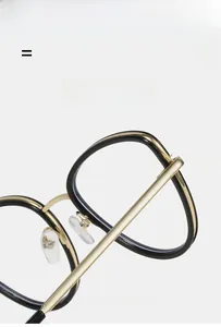 Detail view of cat eye metal frame glasses showing hinges and nose pads in gold finish