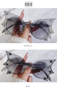 Detail showing grey transparent butterfly sunglasses with rhinestones and star studs