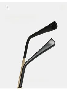 Detailed macro view of curved metal temple with black anti-slip tips for cat-eye glasses