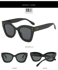 Détail de lunettes de soleil œil de chat avec monture noire et rivets dorés en larmes