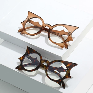 Oversized bat wing cat eye glasses frames in amber and tortoiseshell patterns