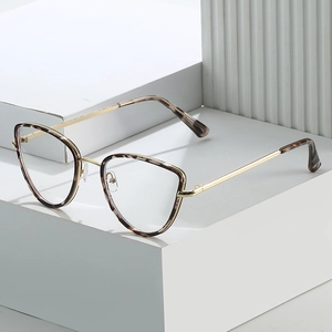 Fashionable tortoise cat-eye metal frame glasses for women on white display stand