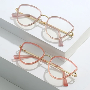 Fashionable cat-eye metal glasses frames in light pink and orange pink on white blocks
