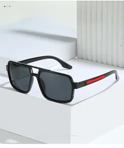 Detail view of polarized sunglasses with black frames and red side stripes on a pedestal