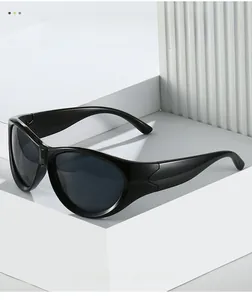 Detail view of glossy black Y2K sports sunglasses on a minimalist white geometric display