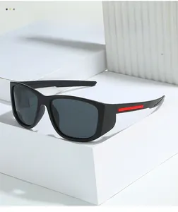 Close-up of matte black frame with red accents and polarized lenses on outdoor sports eyewear